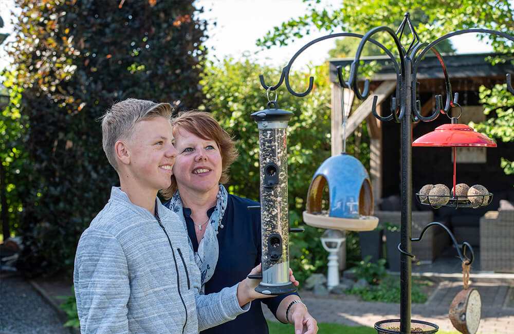 The Apollo feeder is attached to a pole system from which other feeders are also hung.